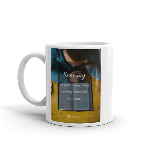 11 oz white cup with definition of knowing the gospel over picture of an reading the Bible