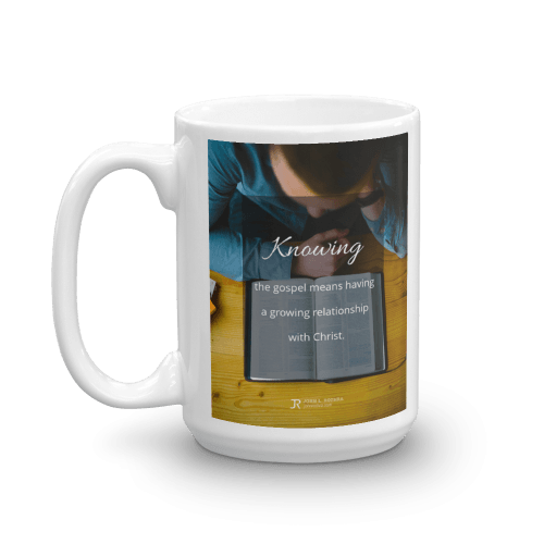 15 oz white cup with definition of knowing the gospel over picture of an reading the Bible