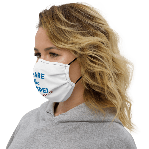 Woman wearing white face mask with black stitching with Share the gospel not a virus